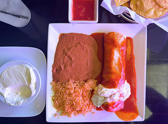 Wall Art - Photograph - Burrito al Carbon with enchilada sauce and a side of sour cream. Served with tortilla chips and queso. by Mike Worley