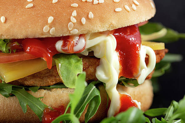 Cheeseburger with a lot of arugula and sauces by Sebastian Radu Cheeseburger with a lot of arugula and sauces by Sebastian Radu