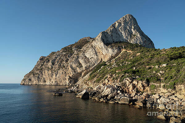 Wall Art - Photograph - Cove and cliffs at Penon de Ifach in Calpe by Adriana Mueller