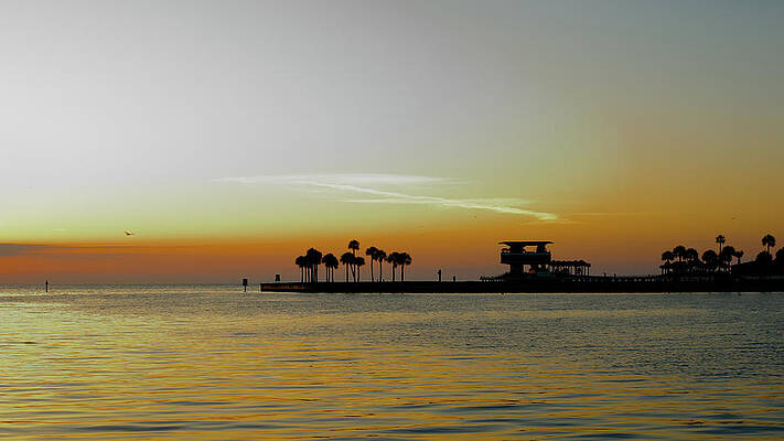 Early Morning Sun Silhouette Water in Bay with Pier by Delbert Harper