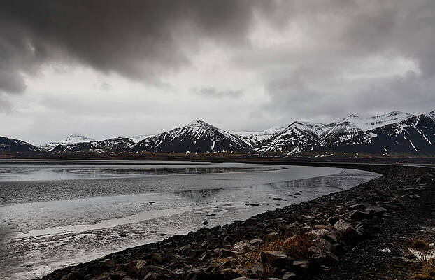 Wall Art - Photograph - Icelandic landscape with frozen lake and mountains covered in snow in Iceland by Michalakis Ppalis
