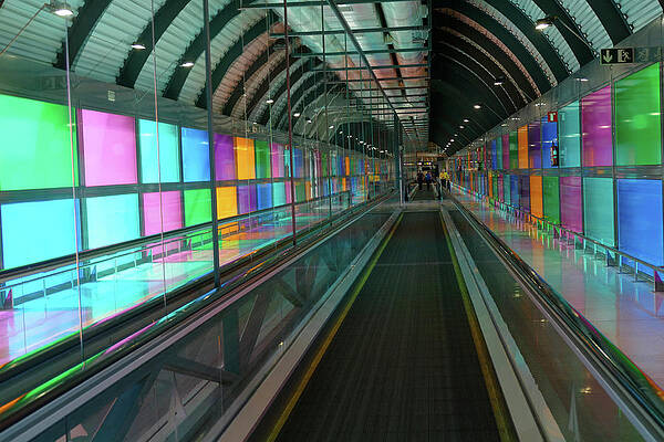 Wall Art - Photograph - Illuminated walkway between terminals of the air by Steve Estvanik