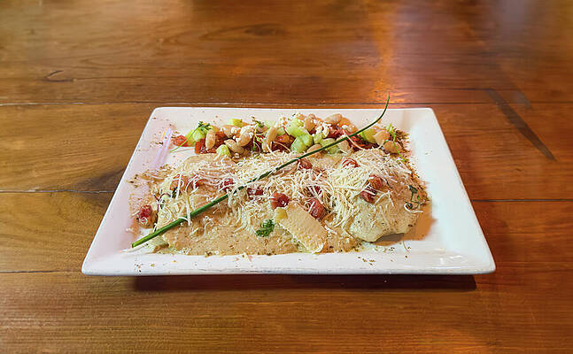 Wall Art - Photograph - Short Rib Ravioli entree and salad on rustic wooden table by Mike Worley
