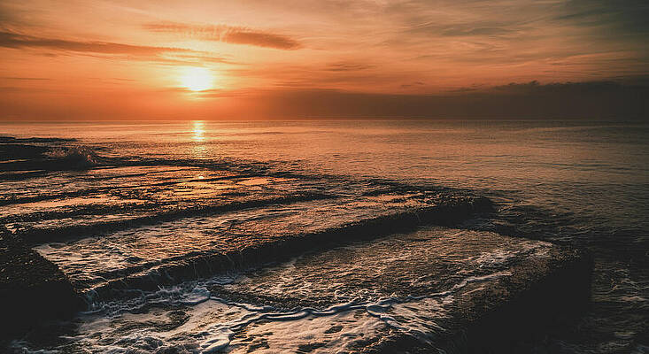 Wall Art - Photograph - The Rhythm of the Tide A peaceful image of waves receding as the sun sets, marking the passage of t by Bob Orsillo