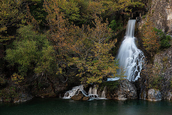 Wall Art - Photograph - Waterfall cascading into mountain river in autumn by Michalakis Ppalis