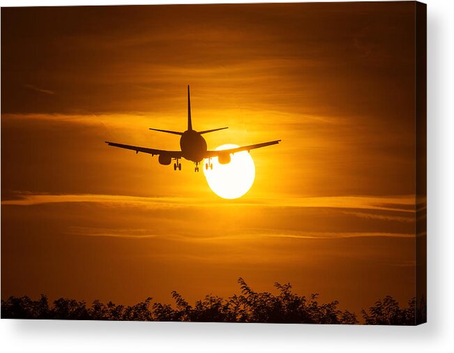Wind Acrylic Print featuring the photograph Silhouette of an air plane over the sun with beautiful red clouds in background #1 by Danm