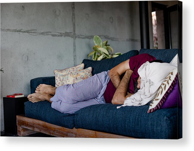 Cold And Flu Acrylic Print featuring the photograph A man lying down on a sofa, sleeping by Photographer, Basak Gurbuz Derman
