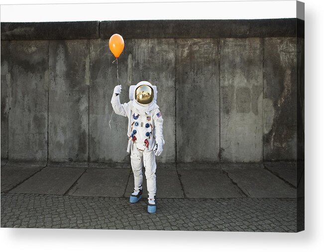 Young Men Acrylic Print featuring the photograph An astronaut on a city sidewalk holding a balloon by fStop Images - Caspar Benson