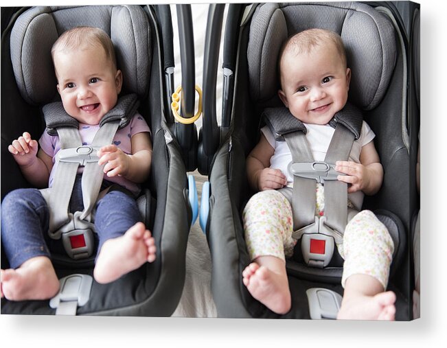 Car Interior Acrylic Print featuring the photograph Caucasian twin baby girls in car seats by JGI/Jamie Grill