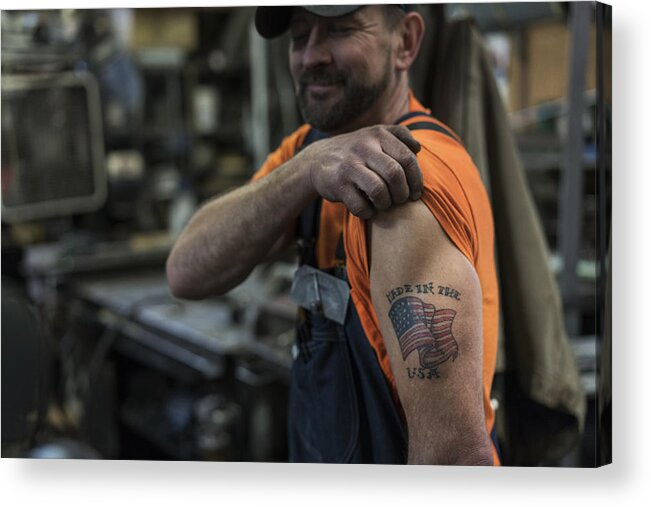 Tacoma Acrylic Print featuring the photograph Caucasian worker displaying tattoo in factory by Jetta Productions Inc