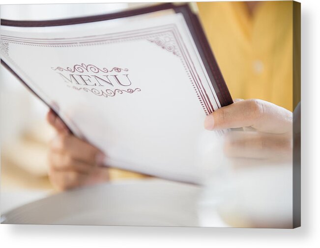 People Acrylic Print featuring the photograph Close up of mixed race man reading menu in restaurant by JGI/Jamie Grill