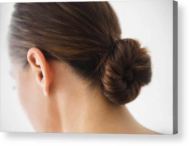 People Acrylic Print featuring the photograph Close up of woman wearing bun in hair by JGI/Jamie Grill
