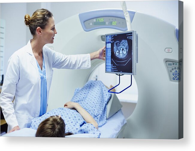 Expertise Acrylic Print featuring the photograph Doctor showing CT scan to patient by Morsa Images