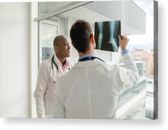 Expertise Acrylic Print featuring the photograph Doctors looking at an x-ray by Andresr