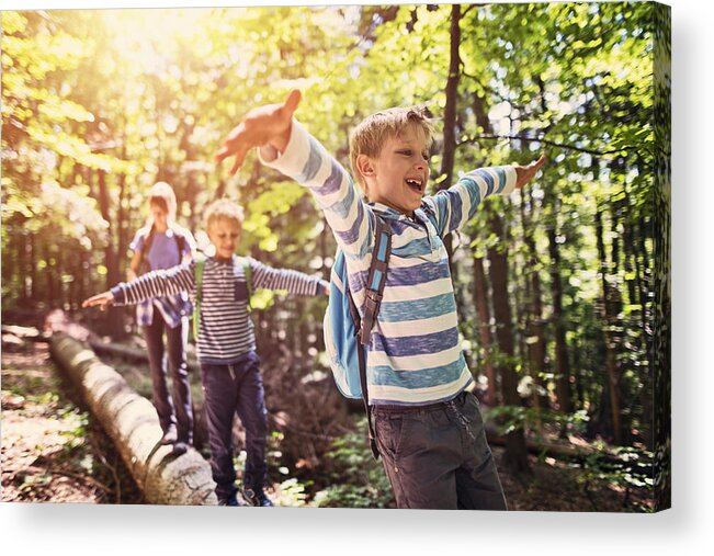 Eco Tourism Acrylic Print featuring the photograph Little hikers walking on a tree trunk in forest by Imgorthand