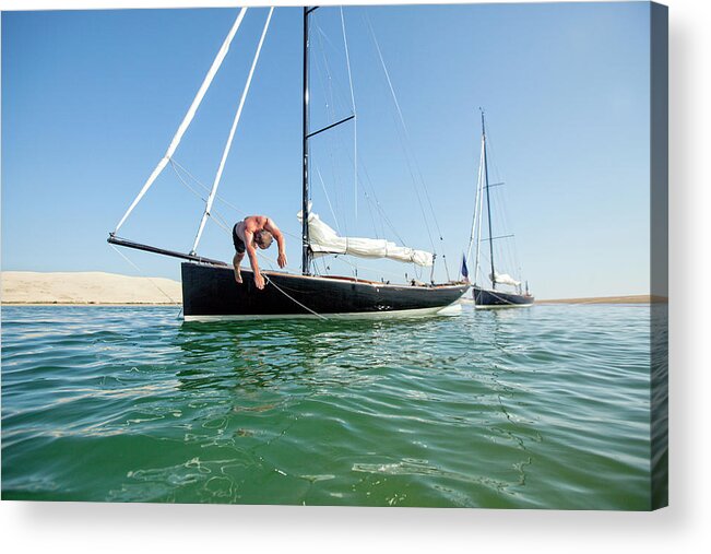 Vacations Acrylic Print featuring the photograph Man Jumping Into Water From Sailboat by Christophe Launay