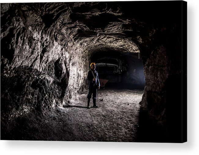 Miner Acrylic Print featuring the photograph Miner working at a mine underground by Andresr