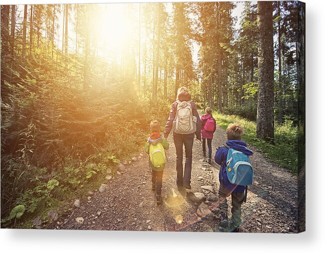 Eco Tourism Acrylic Print featuring the photograph Mother and kids hiking in sunny forest by Imgorthand