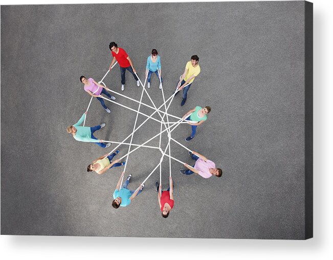 Young Men Acrylic Print featuring the photograph People playing with tangled string by Photo_Concepts