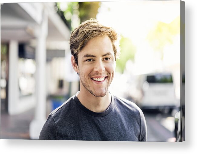 Young Men Acrylic Print featuring the photograph Portrait of smiling young man in city on sunny day by Portra