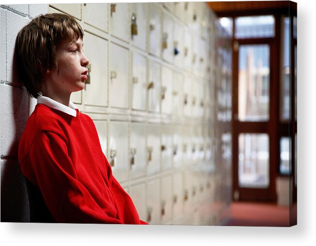 Punishment Acrylic Print featuring the photograph Schoolboy (11-13) sitting in corridor leaning head on wall, side view by Ableimages