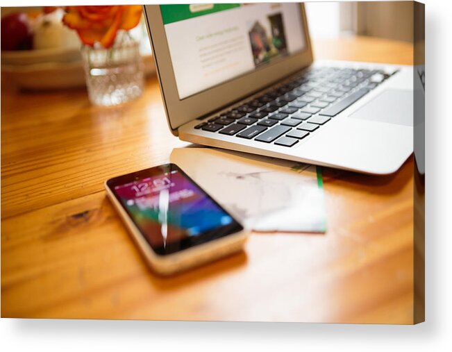 Domestic Room Acrylic Print featuring the photograph Smartphone and laptop on kitchen table by Heshphoto