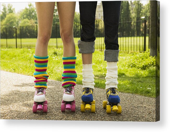 Rolled Up Pants Acrylic Print featuring the photograph Two young women wearing roller skates, low section by Caroline Schiff