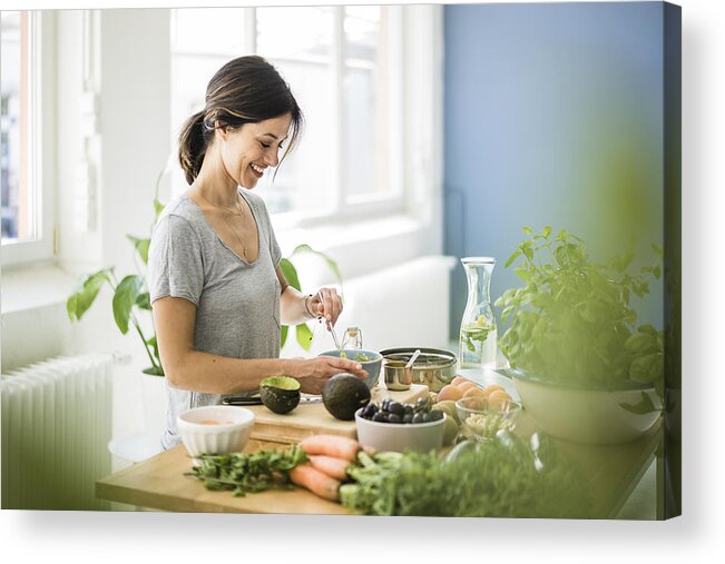 Mature Adult Acrylic Print featuring the photograph Woman preparing healthy food in her kitchen by Westend61