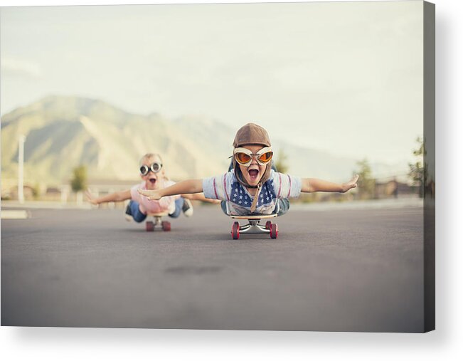 Taking Off Acrylic Print featuring the photograph Young Boy and Girl Imagine Flying On Skateboard by RichVintage