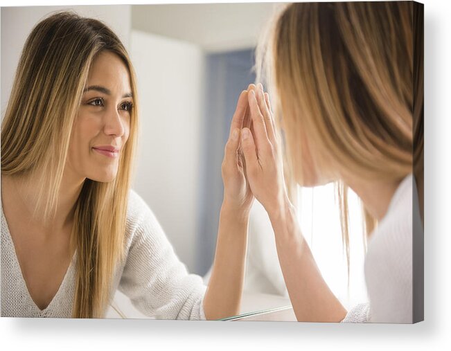 People Acrylic Print featuring the photograph Young woman looking in mirror by Jamie Grill