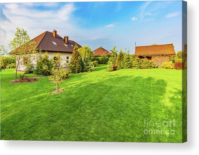 Garden Acrylic Print featuring the photograph Backyard of a family house. Spacious landscaped garden with green mown grass by Michal Bednarek