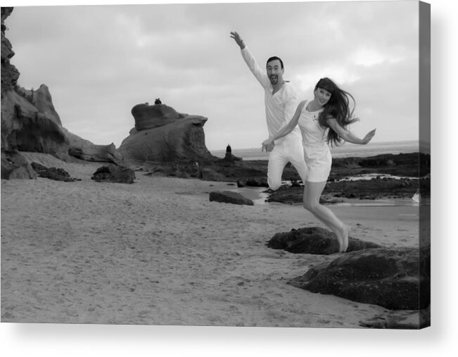  Acrylic Print featuring the photograph Couple leaping off of rock by Garry Loss
