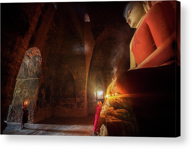 Monk Acrylic Print featuring the photograph Monk in Bagan old town pray a buddha statue with candle by Anek Suwannaphoom