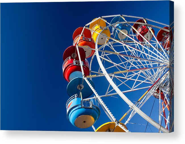 Ferris Wheel Acrylic Print featuring the photograph Rainbow Colored Carriages on Blue by Todd Klassy