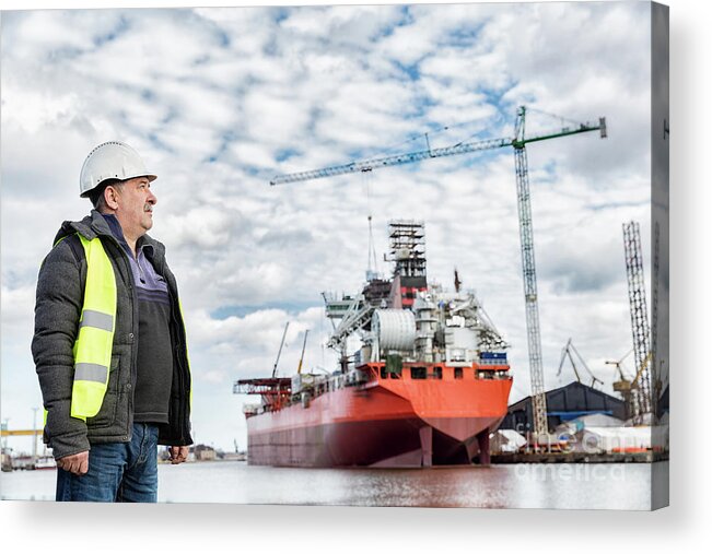 Engineer Acrylic Print featuring the photograph Shipbuilding engineer at the dockside in a port. by Michal Bednarek