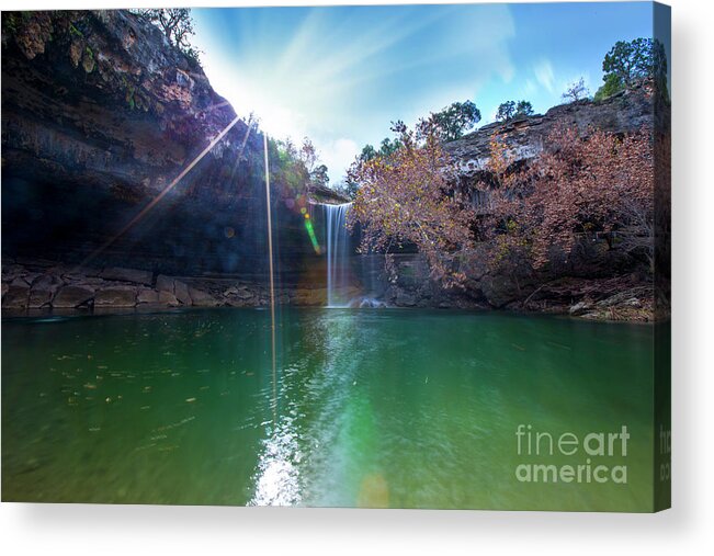 Hamilton Pool Nature Preserve Acrylic Print featuring the photograph Sun rays shimmer through the cliffs at Hamilton Pool Nature Preserve as a beautiful 50-foot waterfall cascades down the pool by Dan Herron