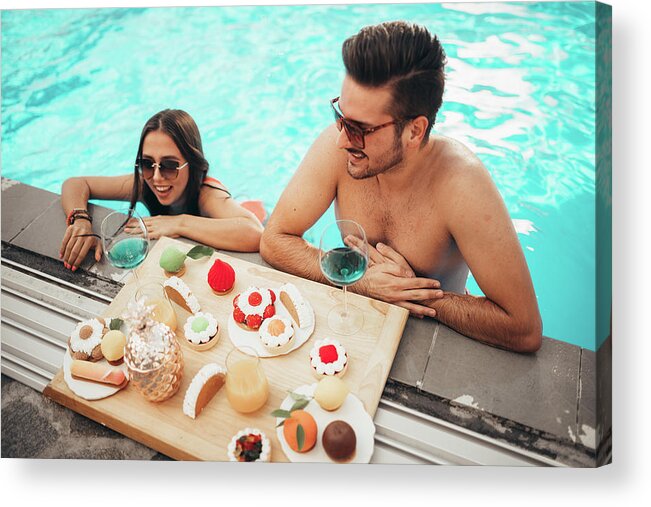 Alcohol Acrylic Print featuring the photograph Beautiful Couple Enjoying Tasty Food In Pool During Tropical Vacation by Cavan Images