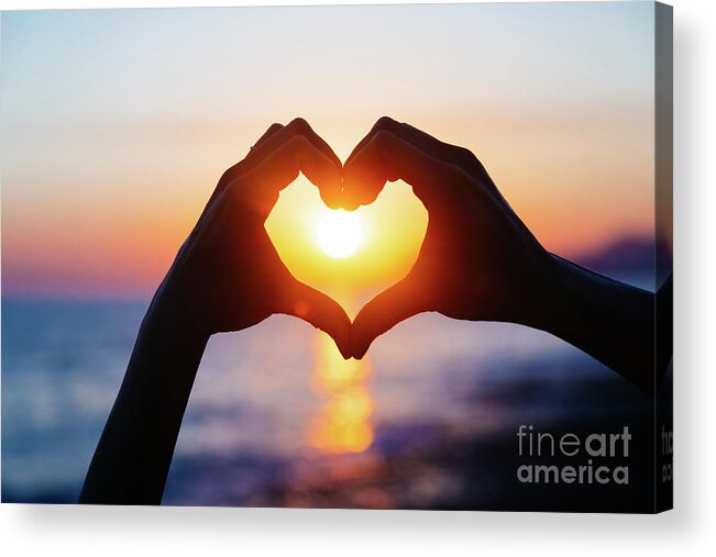 Heterosexual Couple Acrylic Print featuring the photograph Hands Forming A Heart Shape With Sunset by Teraphim