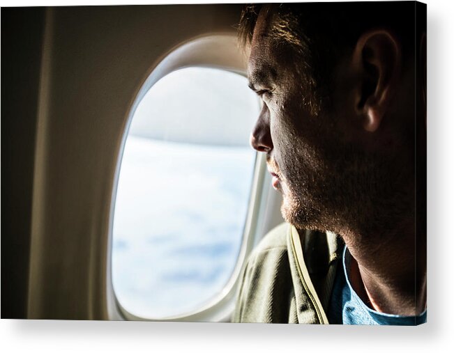 Airplane Acrylic Print featuring the photograph Man With Beard Looks Out The Window Of An Airplane. by Cavan Images
