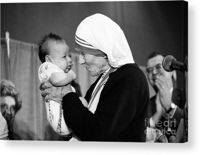 1980-1989 Acrylic Print featuring the photograph Mother Teresa With A Baby by Bettmann