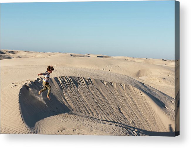 B.c.s. Acrylic Print featuring the photograph One Kid Jumping From A Sand Dune At Dunas De La Soledad by Cavan Images