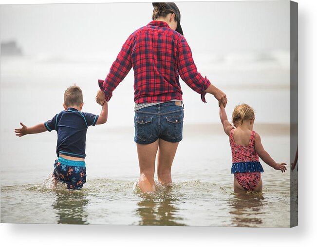 Hands Acrylic Print featuring the photograph Rear View Of Mother Helping Kids Wade Through Water At The Beach. by Cavan Images