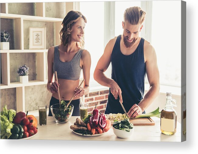 Heterosexual Couple Acrylic Print featuring the photograph Couple cooking healthy food #1 by GeorgeRudy