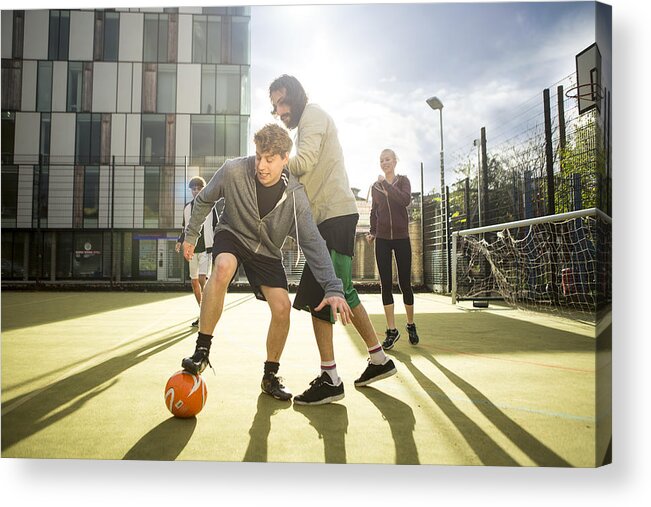 Mid Adult Men Acrylic Print featuring the photograph Group of adults playing football on urban football pitch #1 by Franek Strzeszewski