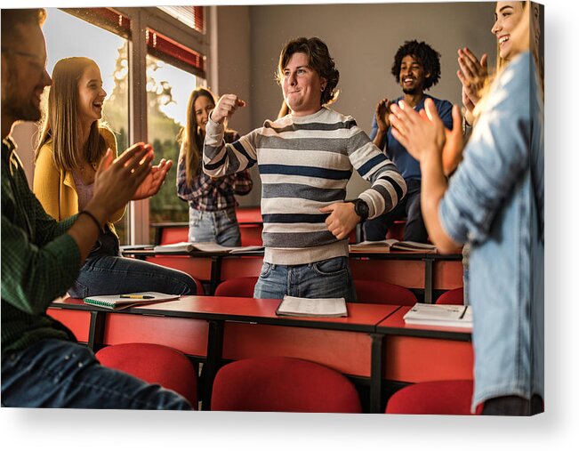 University Acrylic Print featuring the photograph Young students applauding their friend in the classroom. #1 by Skynesher