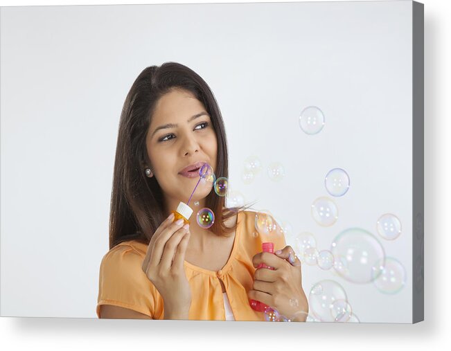 People Acrylic Print featuring the photograph Young woman blowing soap bubbles #1 by Ravi Ranjan
