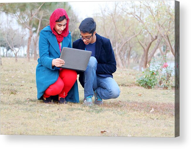 Execution Acrylic Print featuring the photograph A Boy And A Girl Working On Laptop In The Garden #2 by Amir Mukhtar
