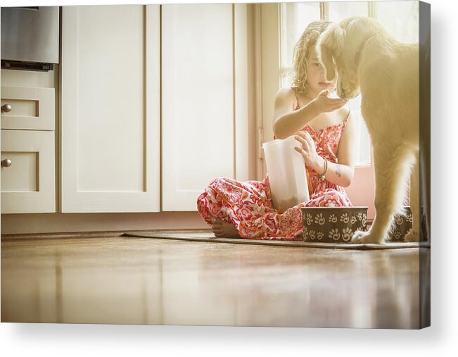 Pets Acrylic Print featuring the photograph Caucasian girl sitting on kitchen floor feeding dog #3 by Terry Vine