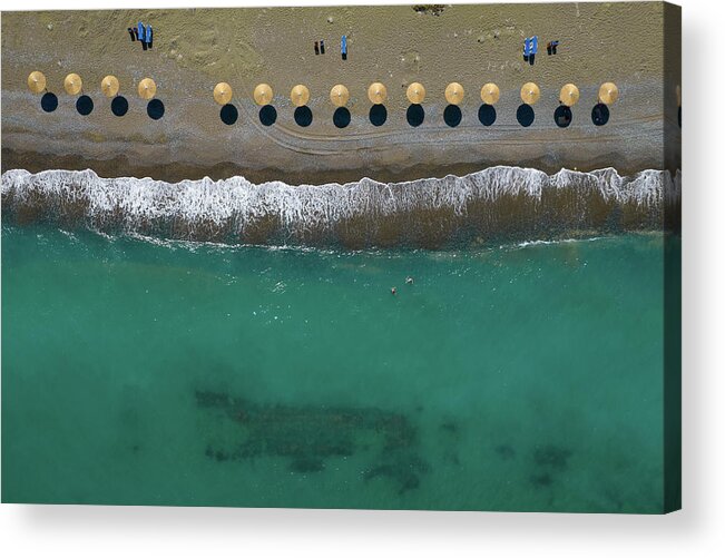  Beach Acrylic Print featuring the photograph Aerial view from a flying drone of beach umbrellas in a row on a by Michalakis Ppalis