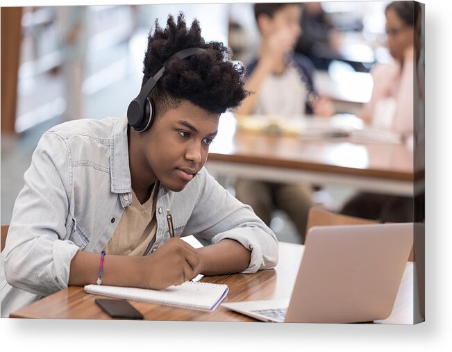 Looking Acrylic Print featuring the photograph African American college student works on research at library by SDI Productions